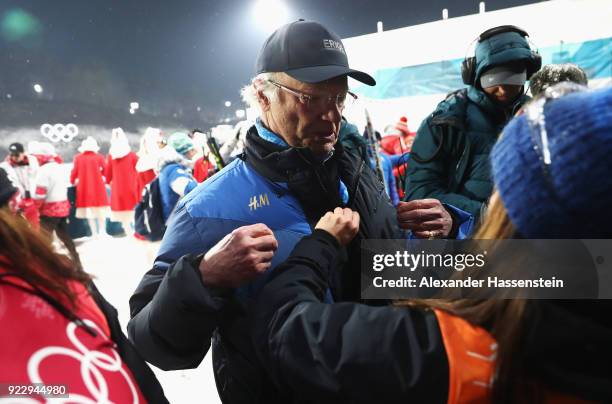 King Carl Gustaf of Sweden celebrates with silver medalist Linn Persson of Sweden after during the Women's 4x6km Relay on day 13 of the PyeongChang...