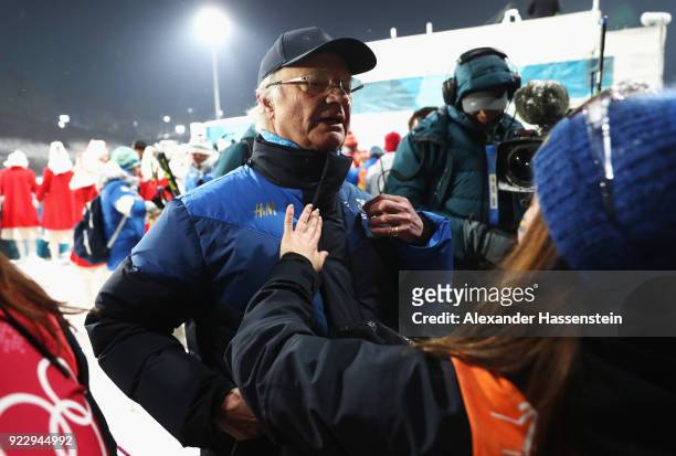King Carl Gustaf of Sweden celebrates with silver medalist Linn Persson of Sweden after during the Women's 4x6km Relay on day 13 of the PyeongChang...