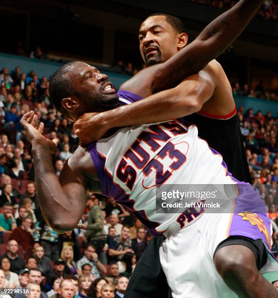 Juwan Howard of the Portland Trail Blazers and Jason Richardson of the Phoenix Suns get tied up together under the basket during their pre-season...