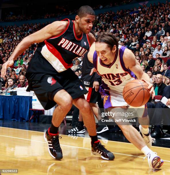 Nicolas Batum of the Portland Trail Blazers tries to stop Steve Nash of the Phoenix Suns as goes dribbles along the baseline during their pre-season...