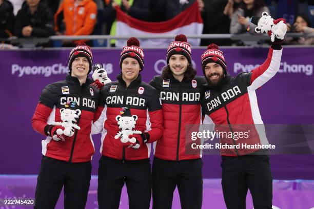 Bronze medalists Samuel Girard, Charles Hamelin, Charle Cournoyer and Pascal Dion of Canada celebrate during the victory ceremony after the Short...