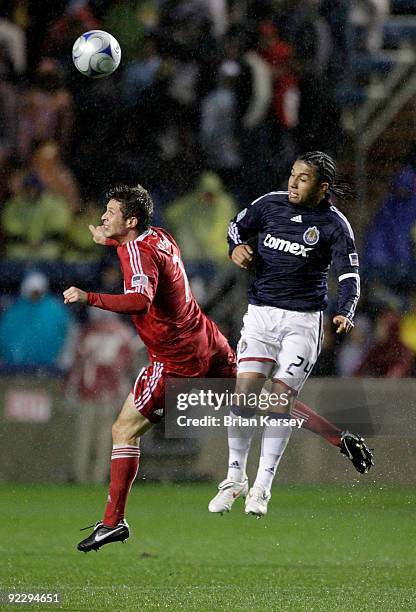 Logan Pause of the Chicago Fire and Gerson Mayen of Chivas USA go up for a header during the first half at Toyota Park on October 22, 2009 in...