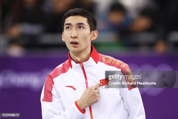 Gold medalist Dajing Wu of China celebrates during the victory ceremony after the Short Track Speed Skating Men's 500m Final on day thirteen of the...