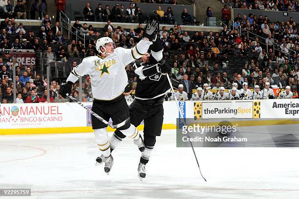 Jamie Benn of the Dallas Stars and Rob Scuderi of the Los Angeles Kings jump for the puck on October 22, 2009 at Staples Center in Los Angeles,...