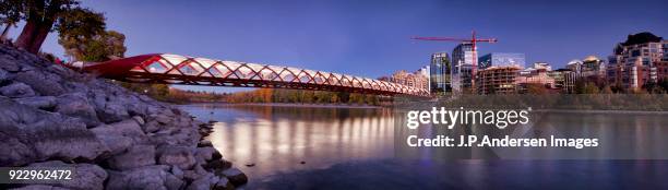 calgary downtown skyline with the peace bridge at dusk - downtown calgary stock pictures, royalty-free photos & images