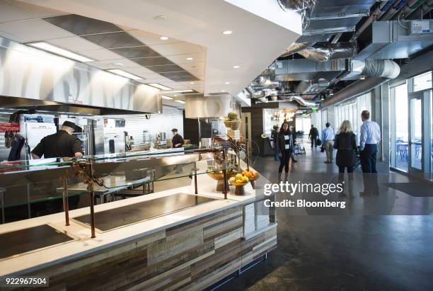 Employees and members of the media stand in the cafeteria of the new Google Inc. Campus in Boulder, Colorado, U.S., on Wednesday, Feb. 21, 2018....