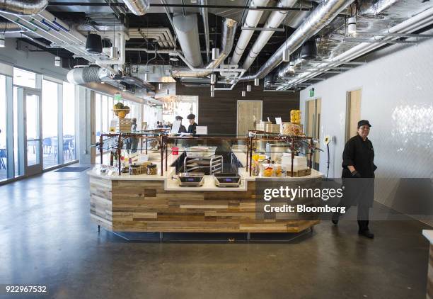 Employees walk through the cafeteria at the new Google Inc. Campus in Boulder, Colorado, U.S., on Wednesday, Feb. 21, 2018. Google moved it's 800...