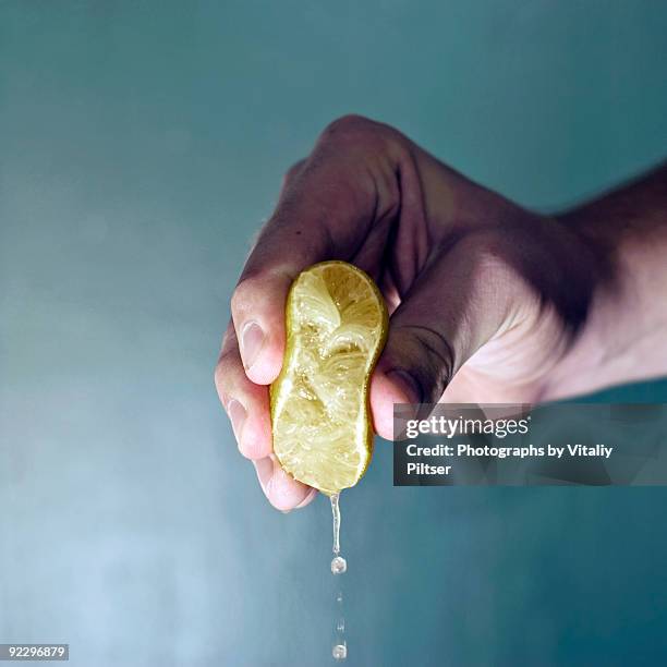 war on sourness. - squeezing imagens e fotografias de stock