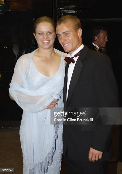 Wimbledon singles champion Lleyton Hewitt of Australia and girlfriend Kim Cljisters pose for photographs at the entrance of the Savoy Hotel in The...