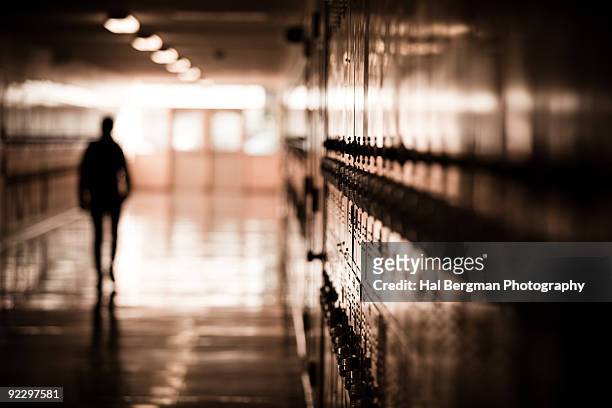 silhouetted man in the building - highschool stock-fotos und bilder