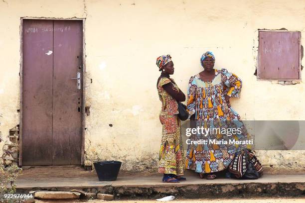 Two women talk at the Mbalmayo, a village south of Yaounde market on February 18, 2018 in Yaounde, Cameroon. Cameroon is often referred to as "Africa...