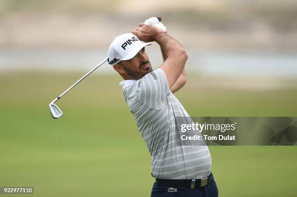 Gregory Havret of France hits an approach shot during the first round of the Commercial Bank Qatar Masters at Doha Golf Club on February 22, 2018 in...