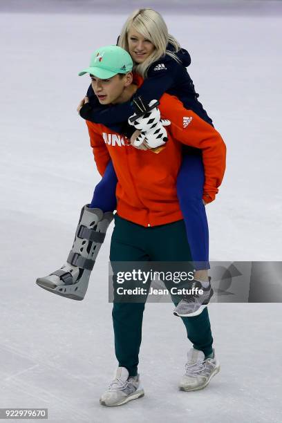 Shaolin Sandor Liu of Hungary carries his girlfriend Elise Christie of Great Britain to the podium in the middle of the rink after the venue ceremony...