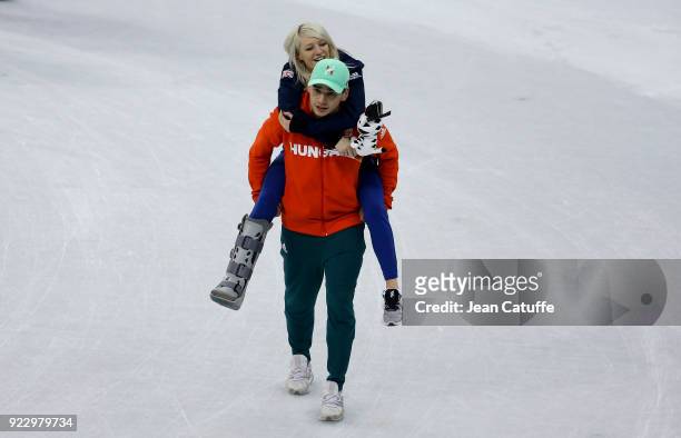 Shaolin Sandor Liu of Hungary carries his girlfriend Elise Christie of Great Britain to the podium in the middle of the rink after the venue ceremony...
