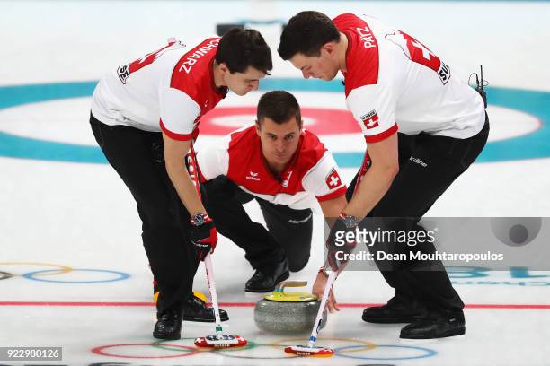 Valentin Tanner, Claudio Patz and Benoit Schwarz of Switzerland compete during the Curling Men's Semi-final against Sweden on day thirteen of the...