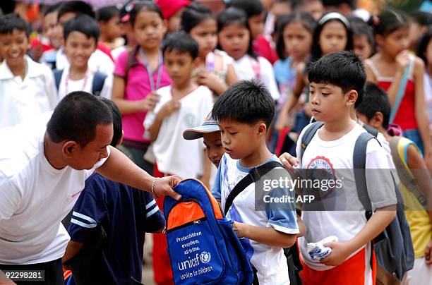 Students from Nangka Elementary School receive school supplies donated by the United Nations Childrens Fund in Marikina, east of Manila on October...