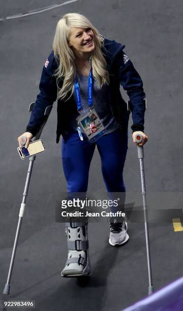 Elise Christie of Great Britain, with crutches wearing a cast on her right foot, looks on after attending the venue victory ceremony with her...