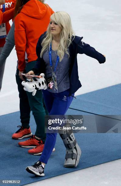 Elise Christie of Great Britain, with crutches wearing a cast on her right foot, looks on after attending the venue victory ceremony with her...