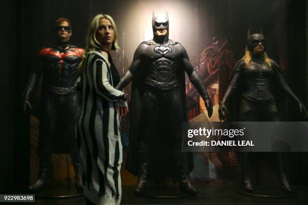 An employee poses in front of a Robin costume worn by actor Chris O'Donnell in 'Batman and Robin' 1997 and designed by Bob Ringwood and Robert...