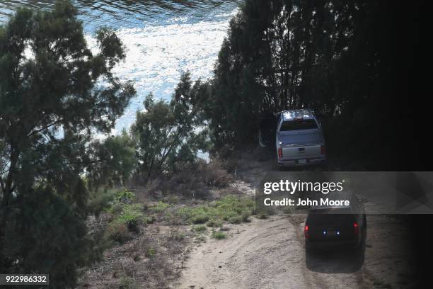 Pickup truck sits crashed at the bank of the Rio Grande after evading capture by U.S. Border agents on February 21, 2018 in McAllen, Texas. Air...