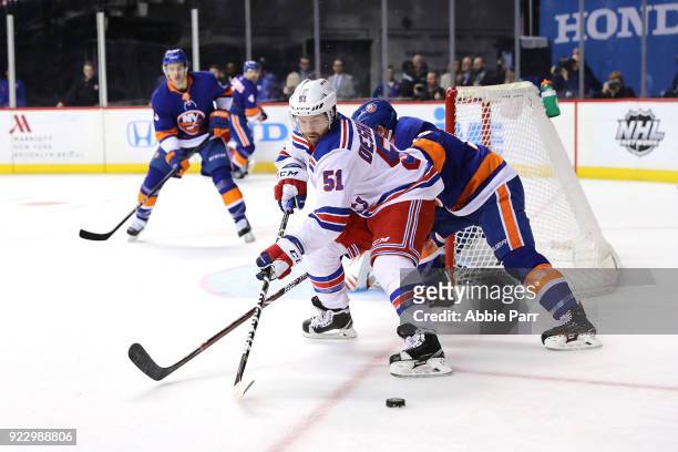 David Desharnais of the New York Rangers reaches for the puck against the New York Islanders in the first period during their game at Barclays Center...