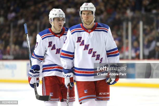 Jesper Fast and Peter Holland of the New York Rangers have a conversation in the second period against the New York Islanders during their game at...