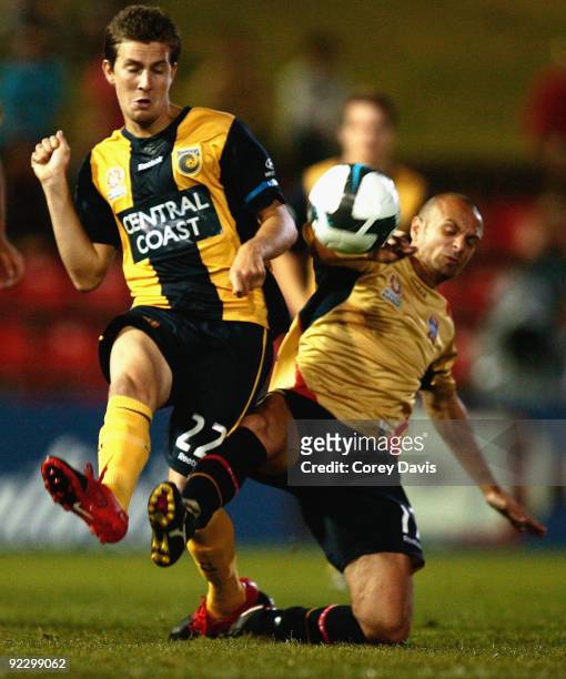 Nicky Travis of the Mariners is challenged by Fabio Vignaroli of the Jets during the round 12 A-League match between the Newcastle Jets and the...