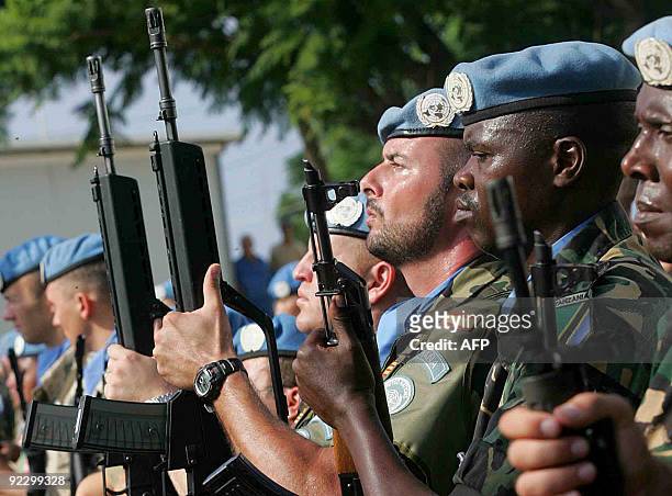 Multi-national soldiers serving with United Nations Interim Force In Lebanon stand to attention during a ceremony marking United Nations Day at the...