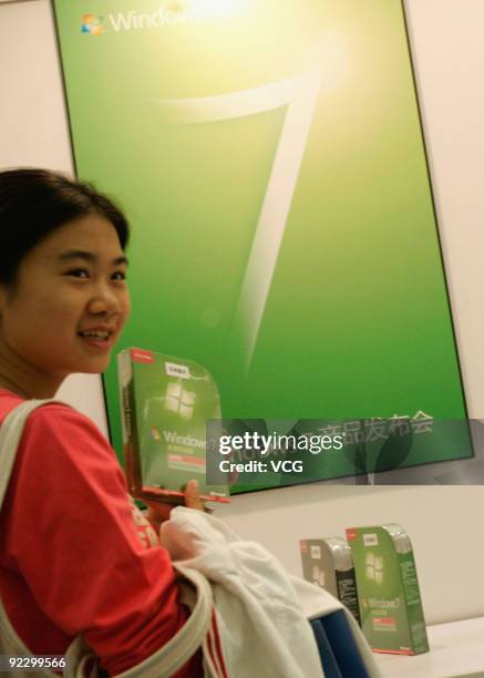 Woman holds the new operating system Microsoft Windows 7 on October 23, 2009 in Beijing, China. Windows 7 is Microsoft's most important release in...