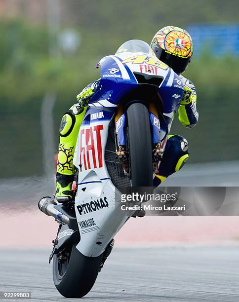 Valentino Rossi of Italy and Fiat Yamaha Team lifts the front wheel during the free practice for the Malaysian MotoGP, which is round 16 of the...