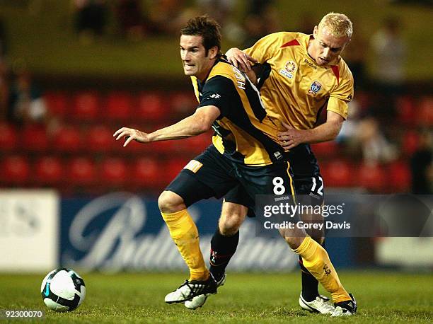 Dean Heffernan of the Mariners is challenged by Jobe Wheelhouse of the Jets during the round 12 A-League match between the Newcastle Jets and the...