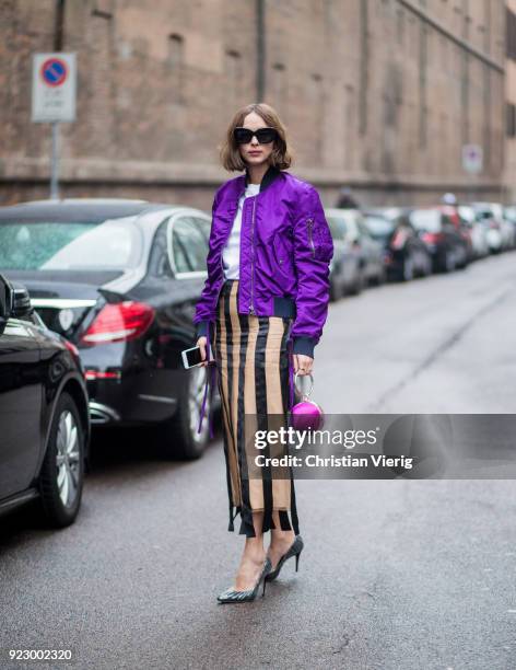 Candela Novembre wearing purple bomber jacket, stripped skirt seen outside Max Mara during Milan Fashion Week Fall/Winter 2018/19 on February 22,...