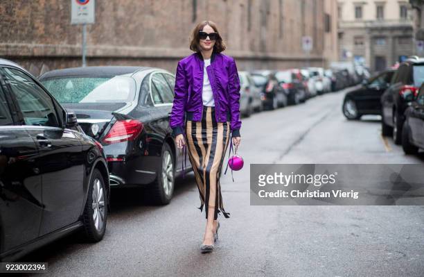 Candela Novembre wearing purple bomber jacket, stripped skirt seen outside Max Mara during Milan Fashion Week Fall/Winter 2018/19 on February 22,...