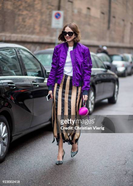 Candela Novembre wearing purple bomber jacket, stripped skirt seen outside Max Mara during Milan Fashion Week Fall/Winter 2018/19 on February 22,...