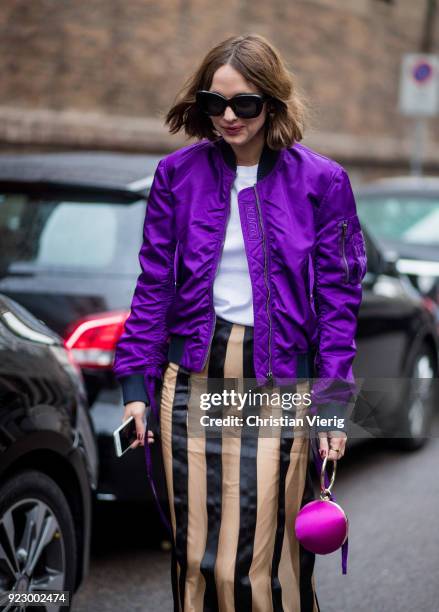 Candela Novembre wearing purple bomber jacket, stripped skirt seen outside Max Mara during Milan Fashion Week Fall/Winter 2018/19 on February 22,...