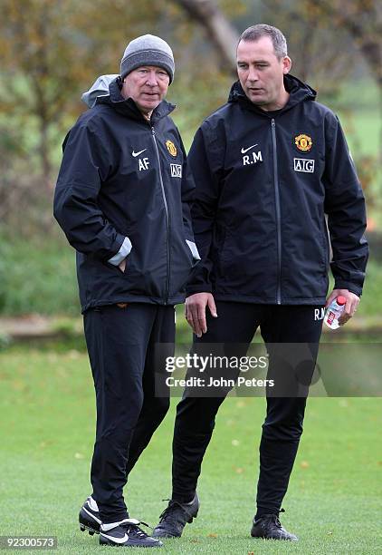 Sir Alex Ferguson and Rene Meulensteen of Manchester United talk during a First Team Training Session at Carrington Training Ground on October 23...