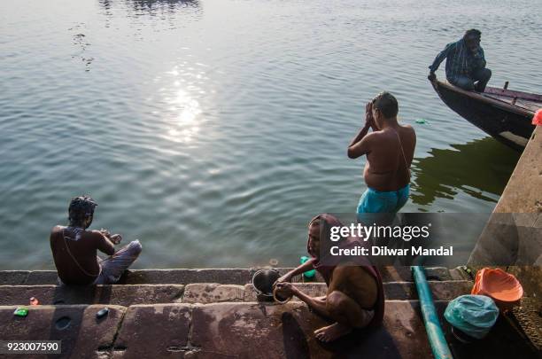 morning activities at varanasi ghats - bathing ghat fotografías e imágenes de stock