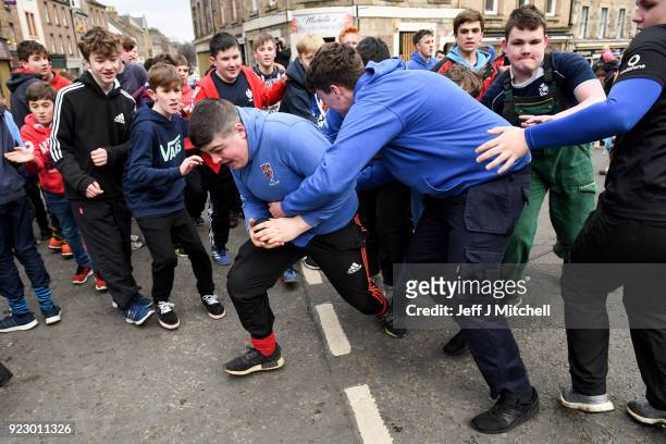 Youths chase after the leather ball during the annual 'Fastern Eve Handba' event in Jedburgh's High Street in the Scottish Borders on February 22,...