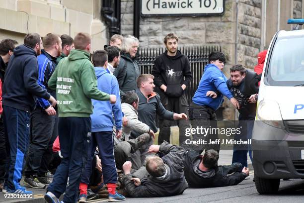 Men chase after the leather ball during the annual 'Fastern Eve Handba' event in Jedburgh's High Street in the Scottish Borders on February 22, 2018...