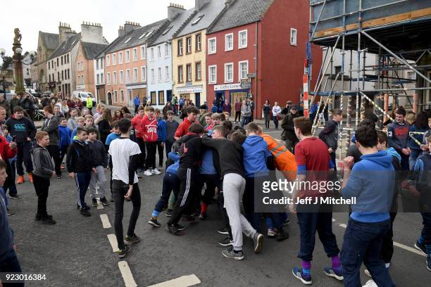 Youths chase after the leather ball during the annual 'Fastern Eve Handba' event in Jedburgh's High Street in the Scottish Borders on February 22,...