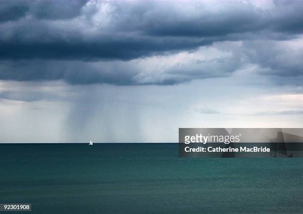 seascape with a single sailing boat - catherine macbride stock pictures, royalty-free photos & images