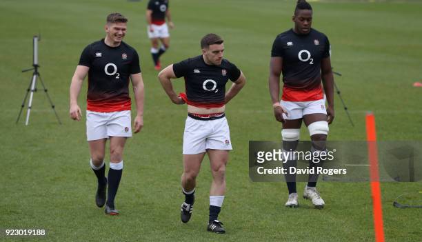 George Ford looks on with team mates Owen Farrell and Maro Itoje during the England training session held at Pennyhill Park on February 22, 2018 in...