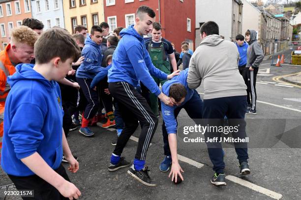 Youths chase after the leather ball during the annual 'Fastern Eve Handba' event in Jedburgh's High Street in the Scottish Borders on February 22,...