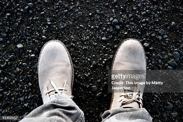 two feet on gravel - suede shoe stock pictures, royalty-free photos & images