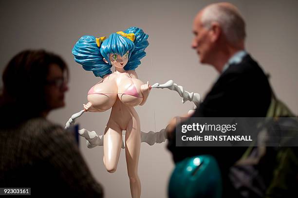 Visitors look at a work of art by Japanese artist Takashi Murakami entitled ' Hiropon 1997' during the press view of the 'Pop Life, Art In A Material...