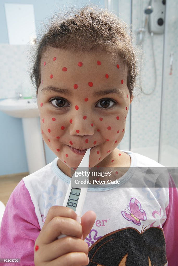 Girl with spots and thermometer