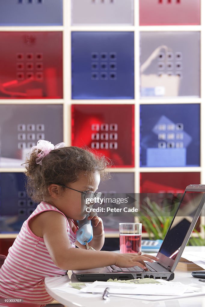 Young girl on phone and laptop