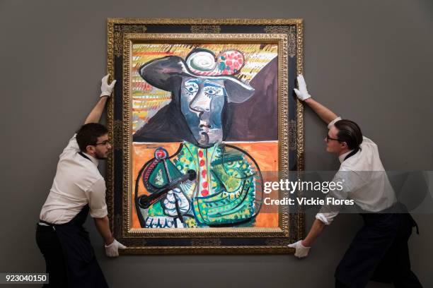 Two members of staff hold Le Matador, by Pablo Picasso, on February 22nd, 2018 at the preview for Sotheby's upcoming Impressionist, Modern and...