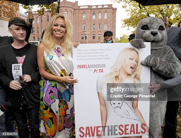 Designer Richie Rich and Pamela Anderson appear with a person dressed as a baby seal to unveil a new PETA campaign at the Ontario Legislative...