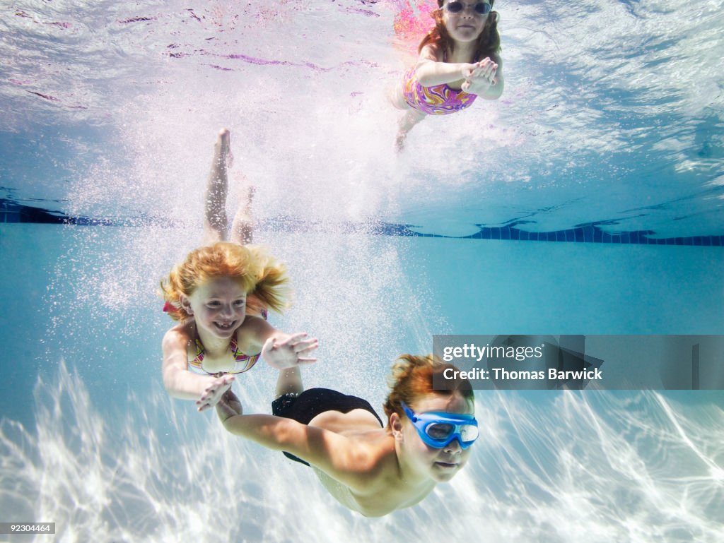 Young boy and two young girls underwater
